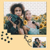 A jigsaw puzzle featuring a photo of two young people looking at the camera.