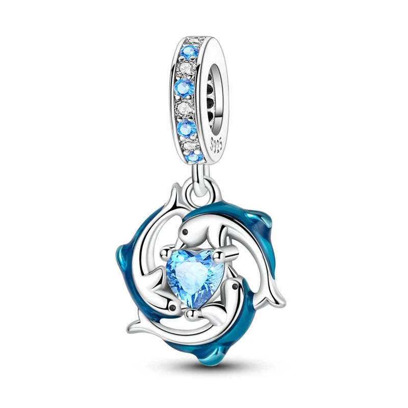 Sterling silver pendant set featuring starfish, sea turtle, and whale shark charms with blue gemstone accents