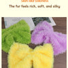 A close-up of three fluffy faux fur yarn skeins in green, purple, and yellow.