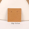 A square brown kraft card with two simple black eyes is displayed on a light background.