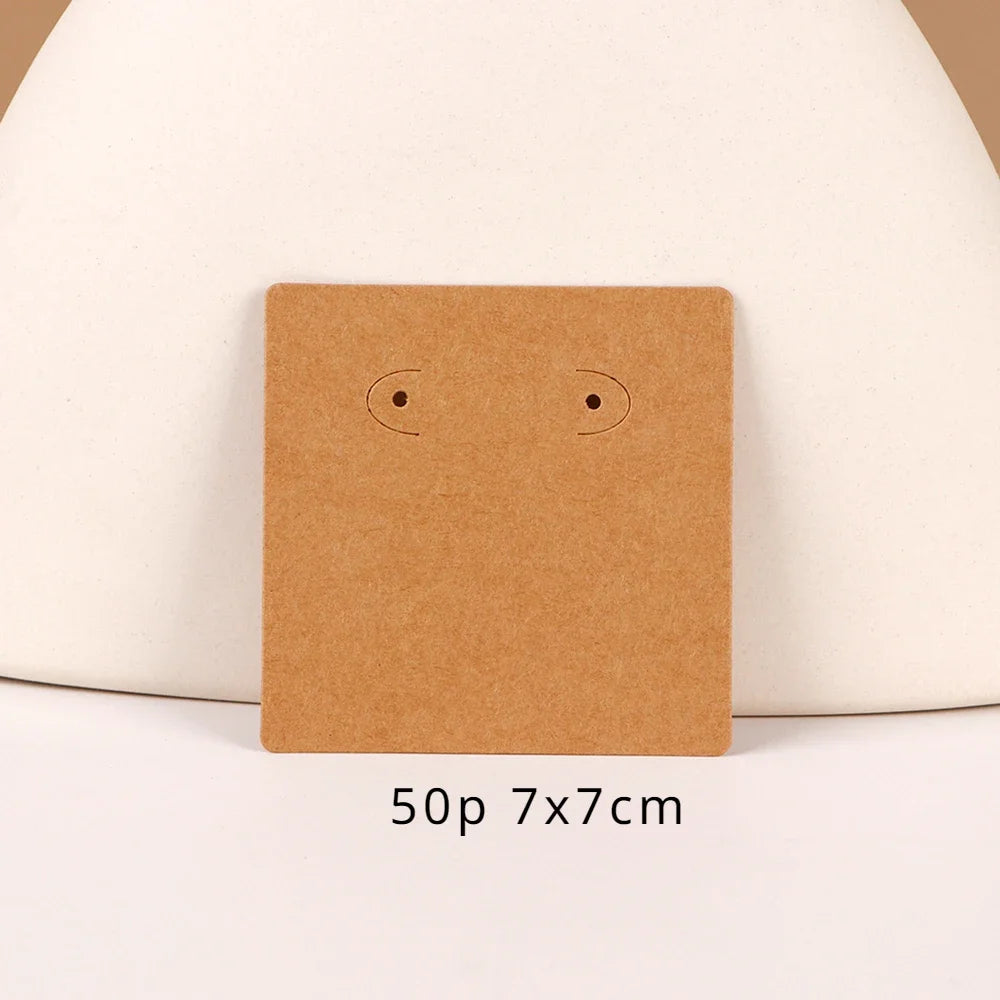 A square brown kraft card with two simple black eyes is displayed on a light background.