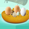 A yellow compact automatic egg incubator holds several brown and white eggs on a light green background.
