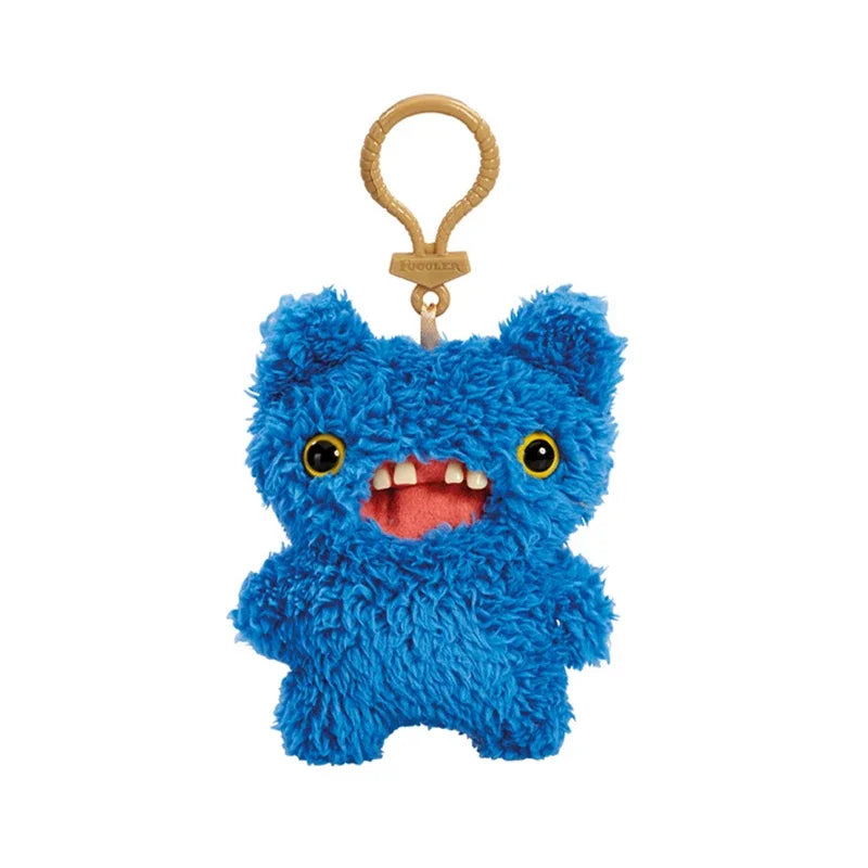 A bright blue, fluffy plush monster keychain with large yellow eyes and a pink mouth.