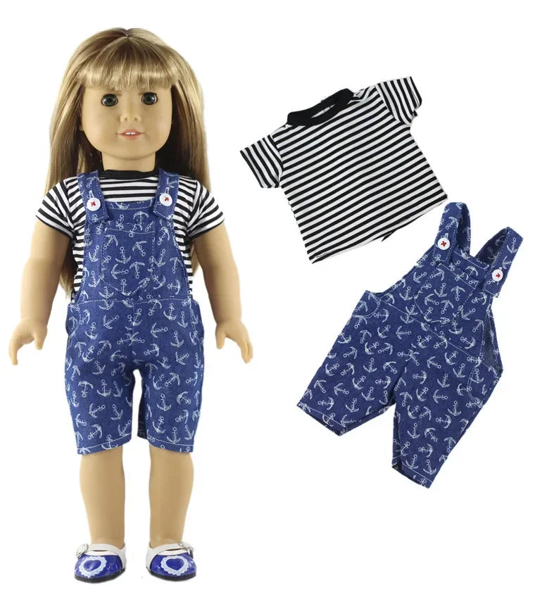 A doll wearing a navy blue patterned outfit set consisting of overalls and a striped shirt.