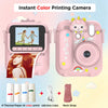 A pink instant color printing camera with a lens, paper, and USB cable shown next to the device.