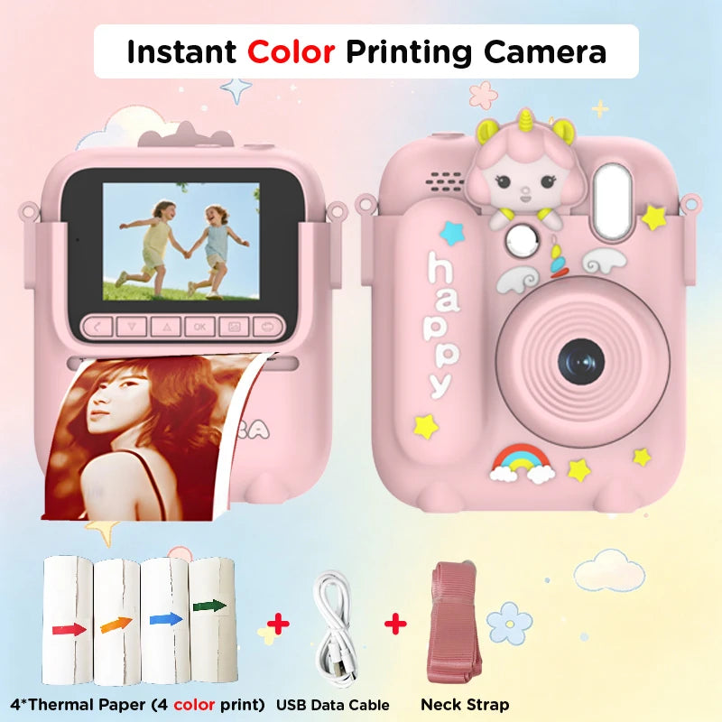 A pink instant color printing camera with a lens, paper, and USB cable shown next to the device.