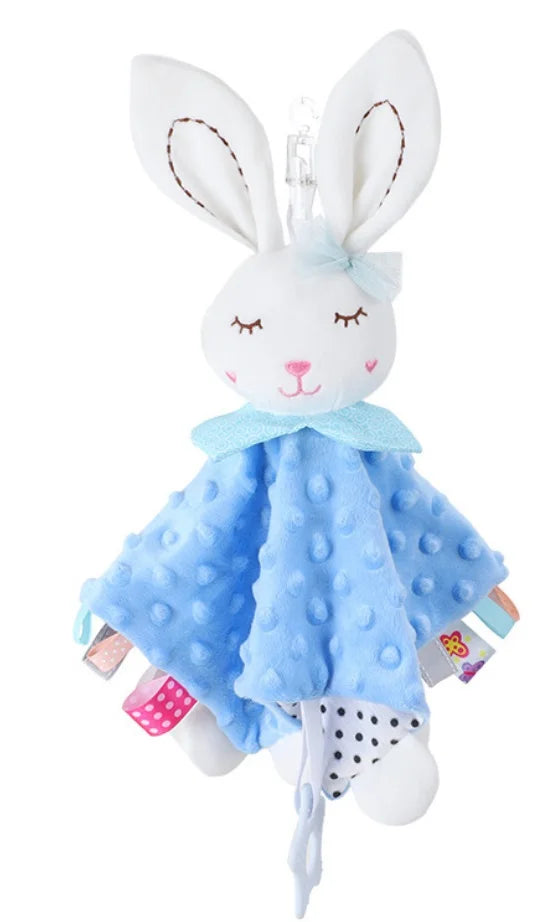 A white bunny plush toy with blue accents and a teether attached.