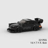 A black classic rally car building block set with orange accents, shown from the side.