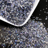 Crushed glass mix with iridescent purple and blue tones in a white dish.