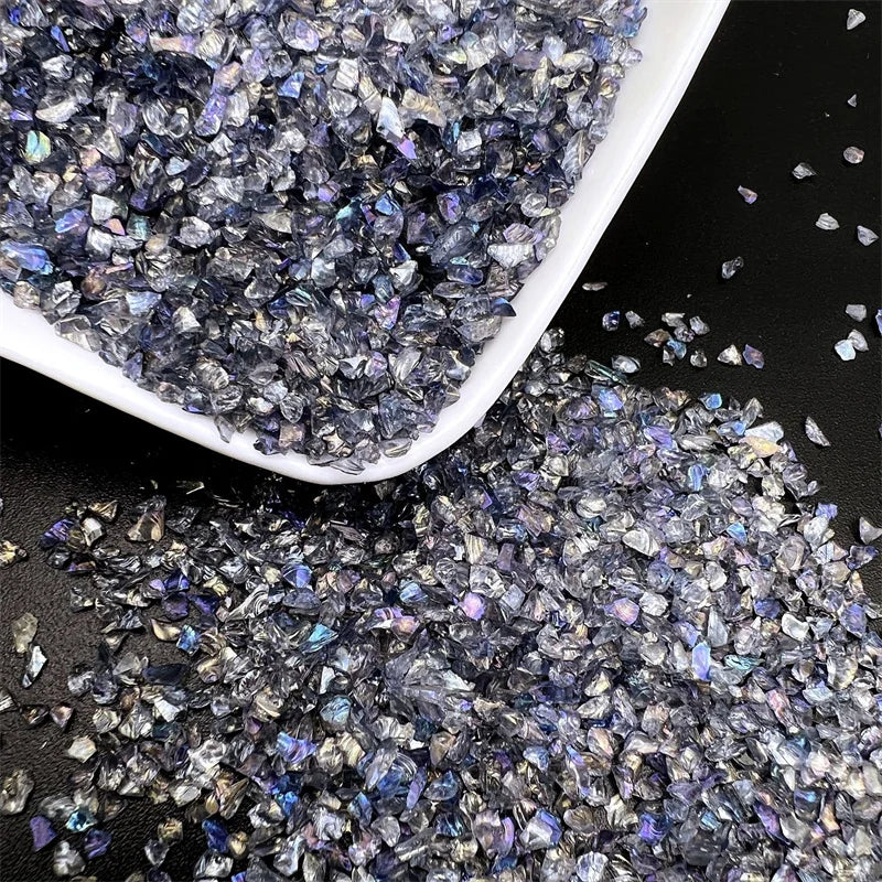 Crushed glass mix with iridescent purple and blue tones in a white dish.