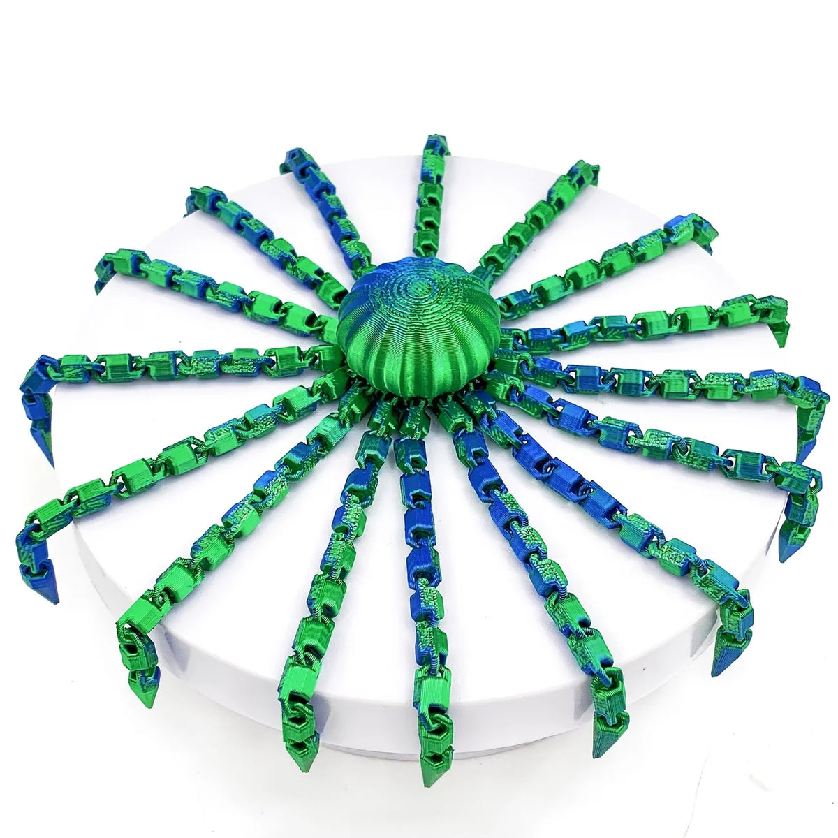 A colorful octopus desktop statue with green and blue tentacles radiating from a central sphere.