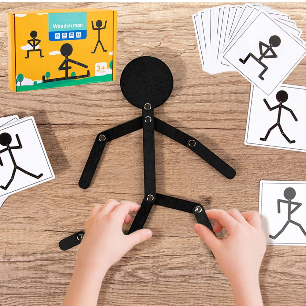 Hands are assembling a black stick puzzle toy set for children on a wooden surface.
