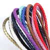 A collection of round braided leather cords in various colors including purple, blue, black, white, and red.