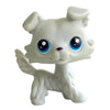 A white bobblehead toy shaped like a deer with large blue eyes.