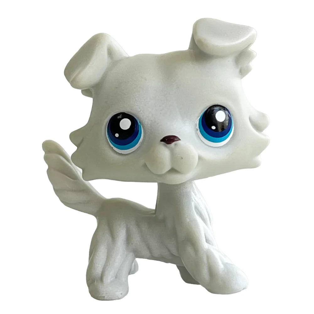 A white bobblehead toy shaped like a deer with large blue eyes.