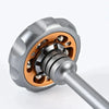 A close-up view of a metal fingertip windmill fidget toy with silver and copper accents.