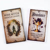 A deck of Wise Witch Oracle Cards featuring an abundance card with a golden chalice and dark purple liquid.