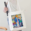 A white tote bag featuring a colorful design of iron-on heat transfer patches and DIY clothing customization elements.