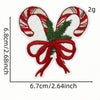 A red and white striped candy cane shaped iron-on patch with a bow, measuring 6.8cm by 2.68inch.