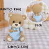 A cute light blue bear cake topper with a brown body and face, shown from the back.
