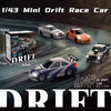 A collection of 1/43 mini drift race cars, including a blue and purple car, orange car, and black car, displayed on a dark ra