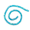 A spiral arrangement of bright blue faceted crystal beads for jewelry making.