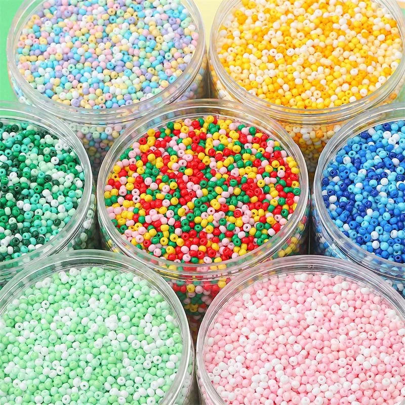 A collection of colorful pony beads in various shades including pink, green, yellow, and blue, displayed in clear jars.