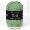 A ball of light green milk cotton yarn labeled with Chinese text and a size indicator.