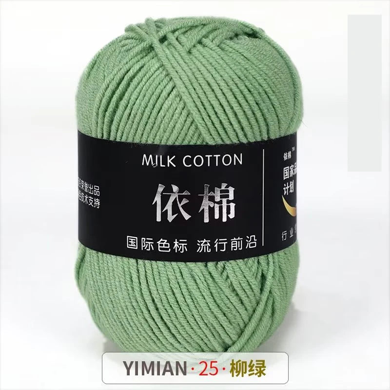 A ball of light green milk cotton yarn labeled with Chinese text and a size indicator.