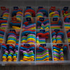 A clear plastic storage box filled with magnetic alphabet spelling kits for kids, showing various letters like Aa, Bb, Cc, et