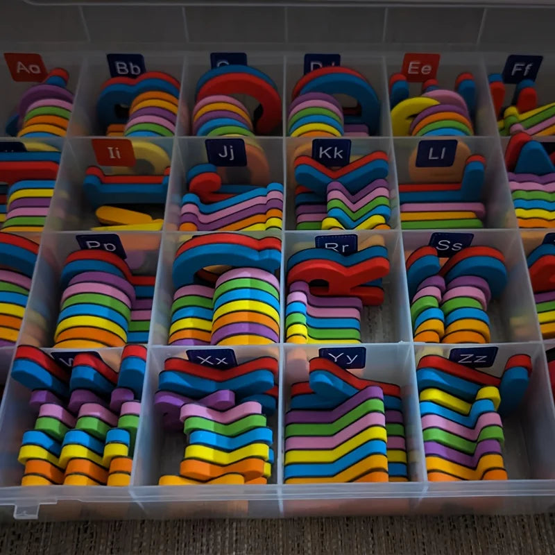 A clear plastic storage box filled with magnetic alphabet spelling kits for kids, showing various letters like Aa, Bb, Cc, et