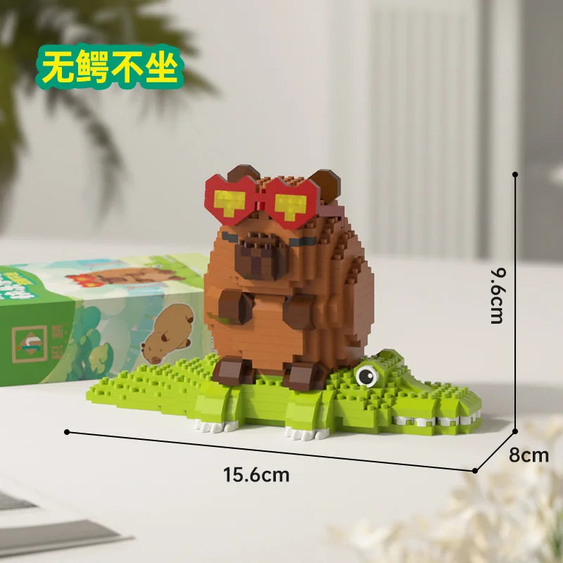 A small wooden building block set depicting a capybara character with red goggles and green foliage.