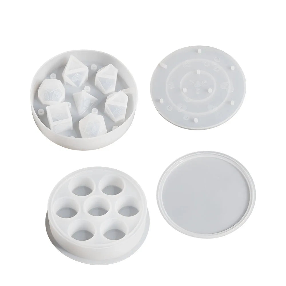 A set of white silicone resin molds including a bowl, a flat disc, and a round tray for custom dice boxes.