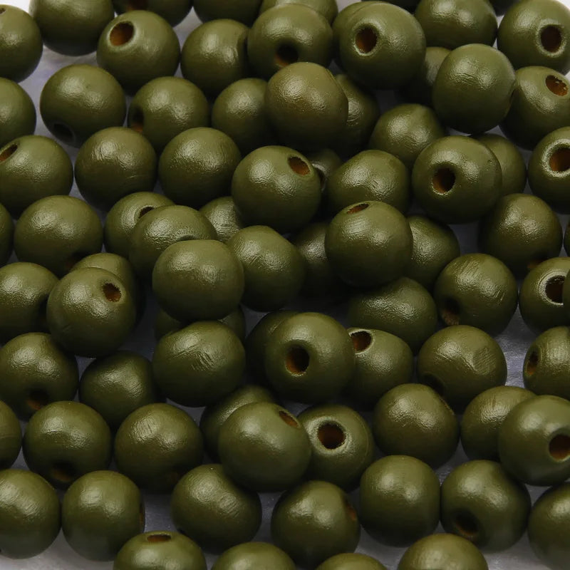 A pile of natural wooden beads in various shades of olive green for jewelry making and crafts.