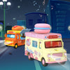A yellow food truck is driving on a street at night with a large pink burger on top.