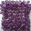 A close-up view of small, faceted purple glass bicone beads for jewelry making.
