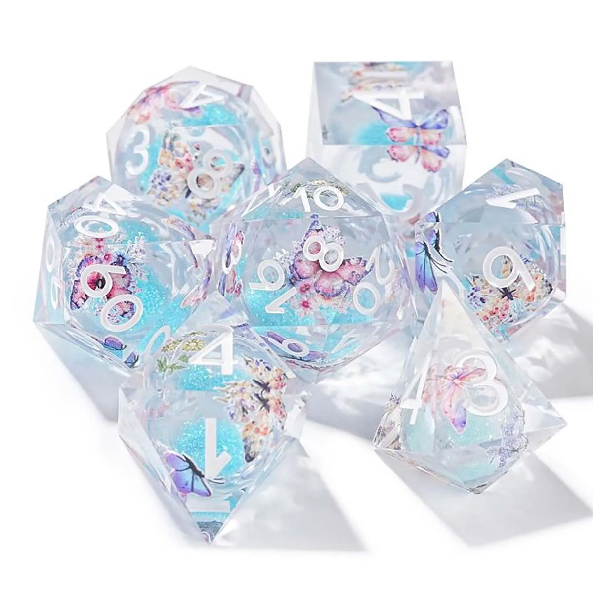 A set of seven pink floral butterfly resin polyhedral dice for tabletop role-playing games