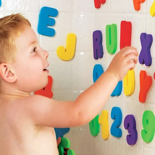 A toddler is interacting with a wall display of colorful alphabet letter puzzles.
