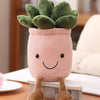 A pink knitted plush toy shaped like a small plant with green leaves and brown feet.
