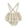 A cream knitted baby outfit set for a girl featuring a blouse and romper with criss-cross straps.