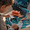 A child is assembling or playing with a blue and orange STEM construction repair toolbox toy set featuring various tools like