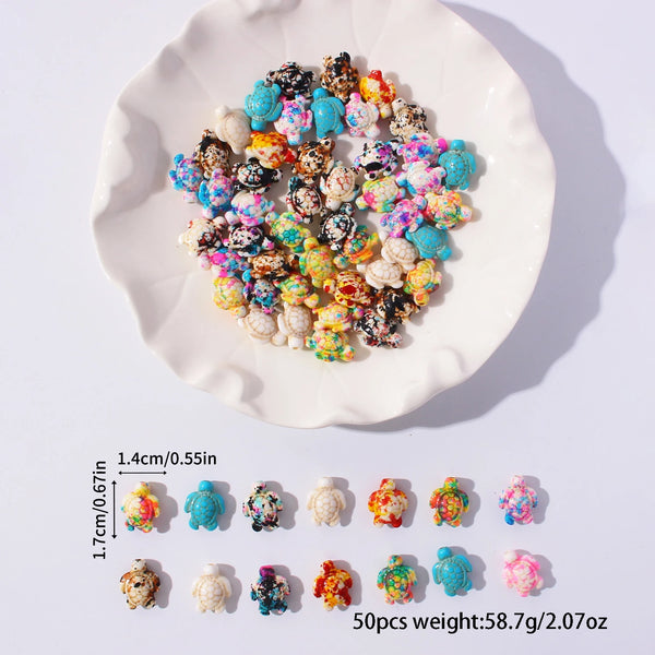 A pile of multicolor ocean turtle beads for jewelry making displayed on a white plate.
