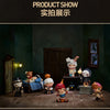 A display of Hirono Monsters Carnival Series collectible figures arranged in a dimly lit room with wooden furniture and windo