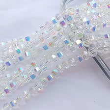 A close-up of a strand of clear glass watermelon loose beads for jewelry making