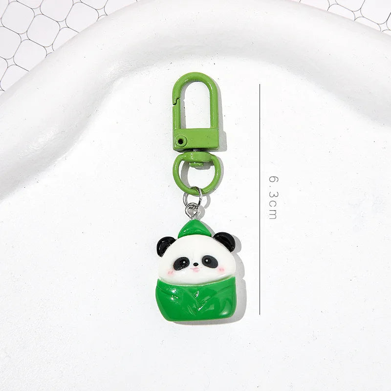 A small green panda charm keychain with a silver ring, shown against a white background.