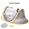 A light gray instant pop-up baby tent with a clear mesh canopy and yellow trim, shown open for display.