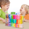 A colorful set of vibrant air dry modeling clay tubes in various colors is displayed on a table with two smiling children.