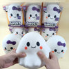 Hands hold a white ghost squishy stress relief toy next to packaged versions.