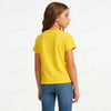 A young girl wearing a bright yellow short-sleeved t-shirt and blue jeans.