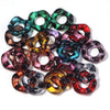 Assortment of candy colored acrylic spacer beads in various shades of green, purple, and red.